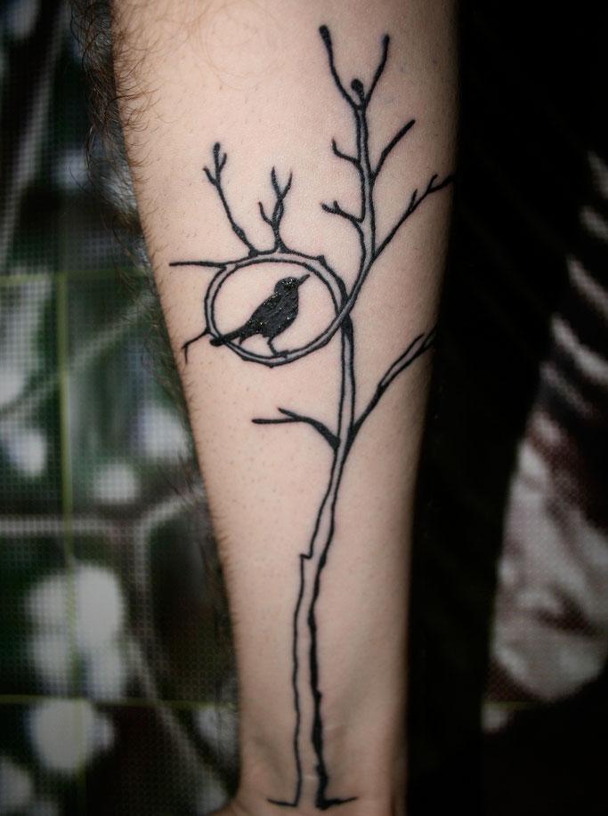 Michael's bird in a tree forearm tattoo